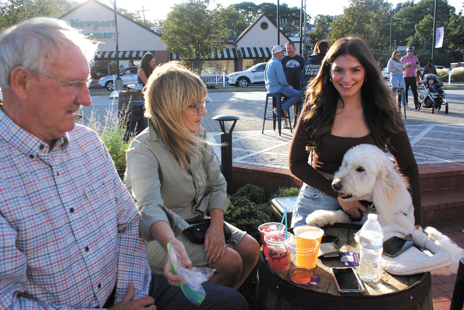 ENJOYING THE DAY: (From left) Nick and Krista Barney and Brianna Lawless with her four-year-old golden doodle Stella enjoy a nice summer day at Garden City’s event.